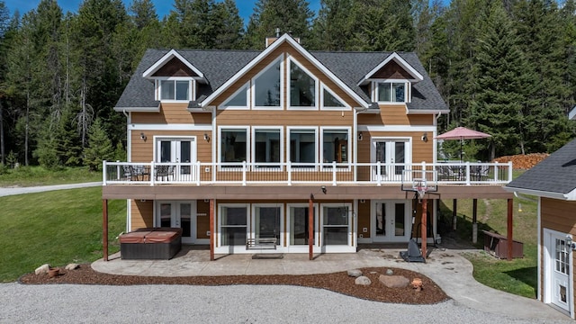 115 Wagon Wheel Rd, Whitefish, MT 59937 - back of house with french doors, a hot tub, and a deck