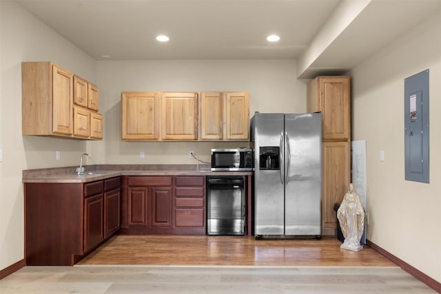 115 Wagon Wheel Rd, Whitefish, MT 59937 - kitchen with stainless steel appliances, light brown cabinets, light wood finished floors, wine cooler, and electric panel
