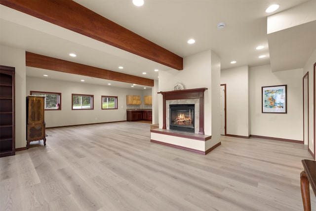 115 Wagon Wheel Rd, Whitefish, MT 59937 - unfurnished living room featuring recessed lighting, beamed ceiling, light wood finished floors, and a high end fireplace