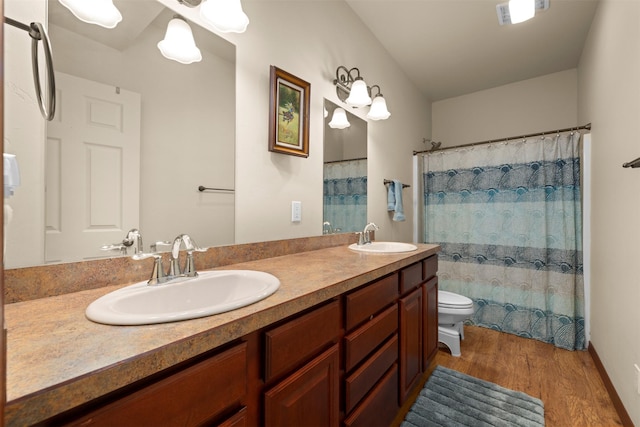 115 Wagon Wheel Rd, Whitefish, MT 59937 - full bathroom featuring wood finished floors, double vanity, and a shower with shower curtain