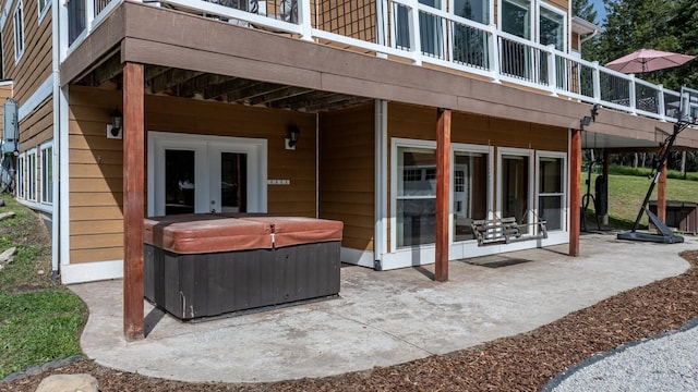 115 Wagon Wheel Rd, Whitefish, MT 59937 - view of patio featuring a hot tub, french doors, and a deck