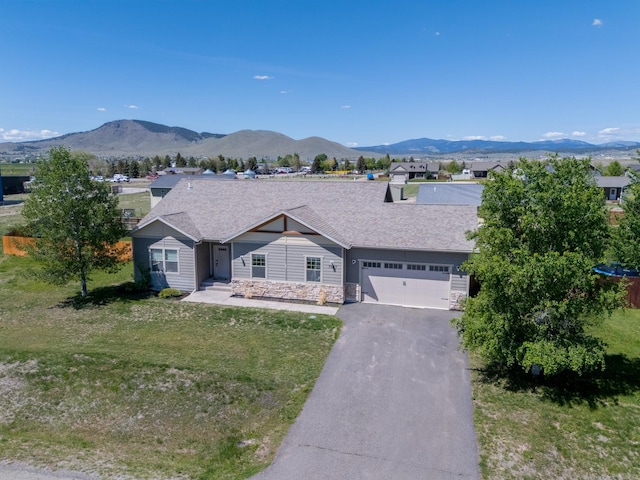 7567 Kingpost Loop, Helena, MT 59602 - ranch-style house with driveway, an attached garage, a front yard, and a mountain view