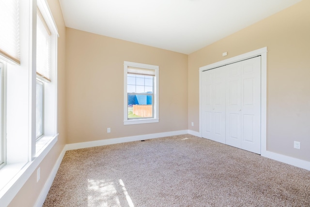7567 Kingpost Loop, Helena, MT 59602 - unfurnished bedroom featuring carpet floors, a closet, and baseboards