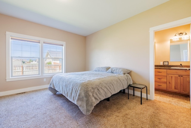 7567 Kingpost Loop, Helena, MT 59602 - bedroom with a sink, baseboards, ensuite bathroom, and light carpet