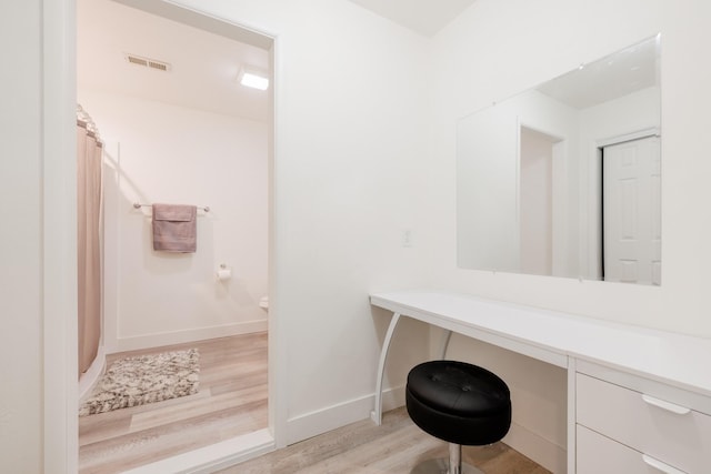 7567 Kingpost Loop, Helena, MT 59602 - full bath with wood finished floors, baseboards, vanity, and curtained shower