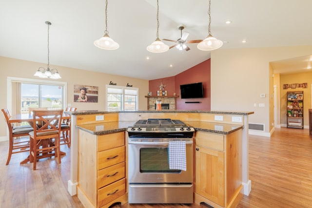 7567 Kingpost Loop, Helena, MT 59602 - kitchen featuring gas stove, lofted ceiling, ceiling fan, light brown cabinets, and light wood finished floors
