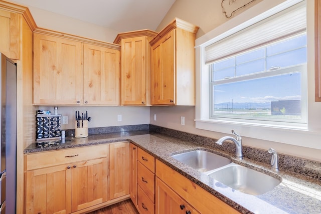 7567 Kingpost Loop, Helena, MT 59602 - kitchen with a sink, light brown cabinetry, dark stone countertops, and stainless steel fridge