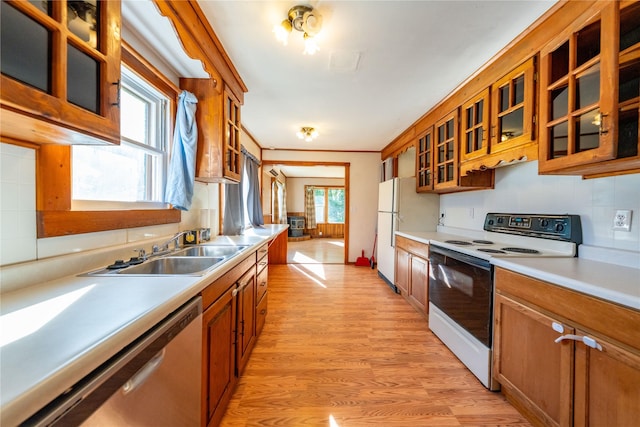 411 Colorado Ave, Libby, MT 59923 - kitchen with white appliances, brown cabinets, light wood finished floors, and light countertops