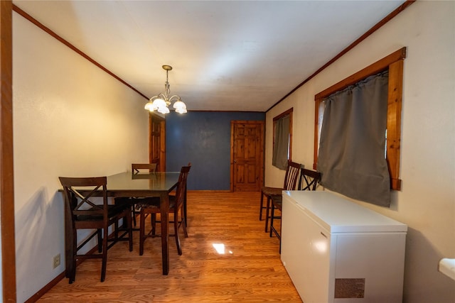 411 Colorado Ave, Libby, MT 59923 - dining area featuring light wood-style floors, crown molding, and a chandelier