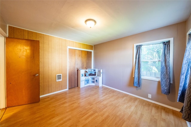 411 Colorado Ave, Libby, MT 59923 - empty room with wood finished floors, baseboards, and heating unit