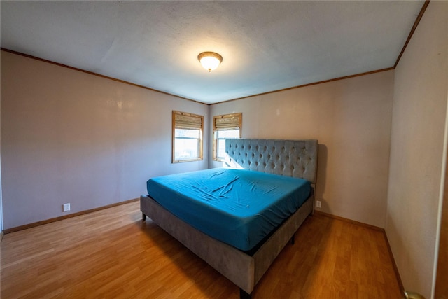 411 Colorado Ave, Libby, MT 59923 - bedroom with crown molding, wood finished floors, and baseboards