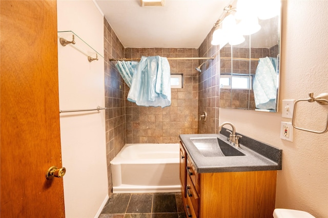411 Colorado Ave, Libby, MT 59923 - bathroom with vanity, washtub / shower combination, toilet, and a textured wall