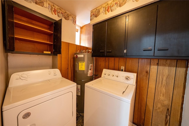 411 Colorado Ave, Libby, MT 59923 - laundry area featuring cabinet space, independent washer and dryer, electric water heater, and wood walls