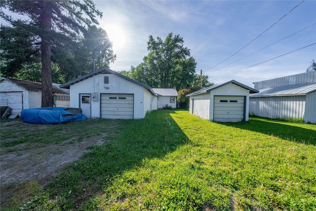 411 Colorado Ave, Libby, MT 59923 - view of grassy yard featuring an outdoor structure and a garage