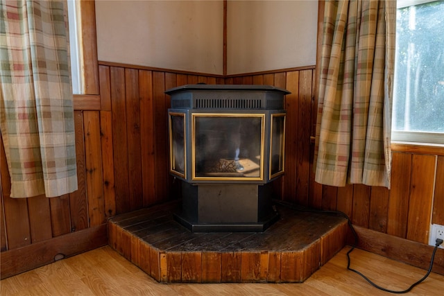 411 Colorado Ave, Libby, MT 59923 - detailed view of a wood stove, wainscoting, wood walls, and wood finished floors