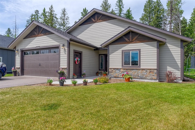 224 Forest Edge Trl, Kalispell, MT 59901 - view of front of house featuring an attached garage, driveway, a front lawn, and stone siding