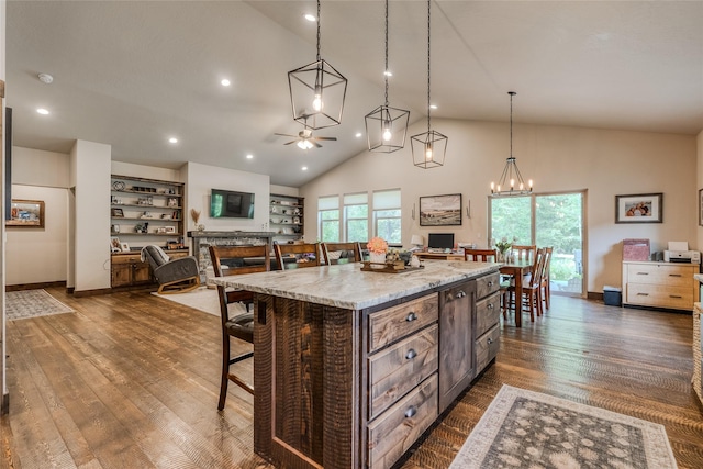 224 Forest Edge Trl, Kalispell, MT 59901 - kitchen featuring ceiling fan, a breakfast bar, open floor plan, pendant lighting, and high vaulted ceiling