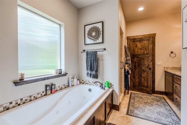 224 Forest Edge Trl, Kalispell, MT 59901 - bathroom with healthy amount of natural light, vanity, a tub with jets, and tile patterned floors