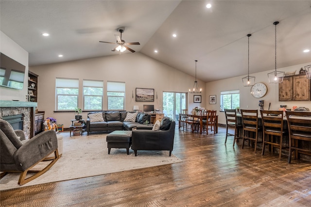 224 Forest Edge Trl, Kalispell, MT 59901 - living room featuring dark wood-type flooring, healthy amount of natural light, a fireplace, a ceiling fan, and high vaulted ceiling