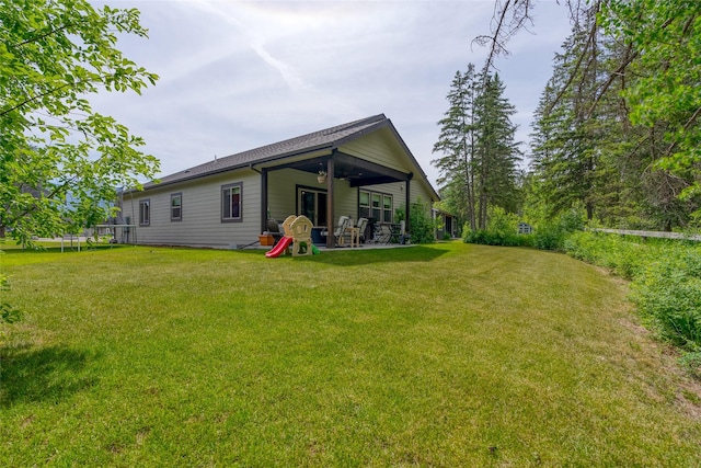 224 Forest Edge Trl, Kalispell, MT 59901 - back of house with a patio, a yard, a ceiling fan, and a trampoline