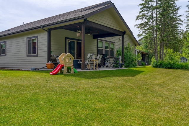 224 Forest Edge Trl, Kalispell, MT 59901 - back of house with a ceiling fan, a patio area, a yard, and a shingled roof