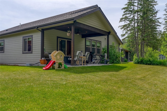 224 Forest Edge Trl, Kalispell, MT 59901 - back of property with a patio area, ceiling fan, a lawn, and a shingled roof