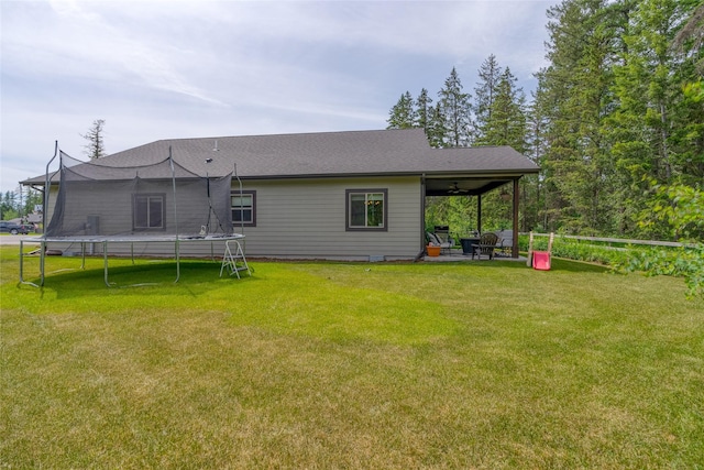224 Forest Edge Trl, Kalispell, MT 59901 - rear view of house with a trampoline, a ceiling fan, a lawn, and a patio