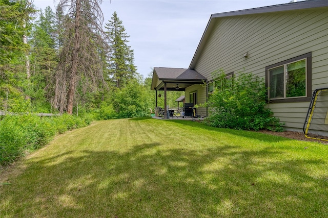 224 Forest Edge Trl, Kalispell, MT 59901 - view of grassy yard featuring a ceiling fan and a patio area