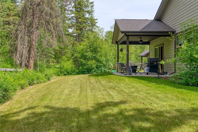 224 Forest Edge Trl, Kalispell, MT 59901 - view of grassy yard with ceiling fan and a patio