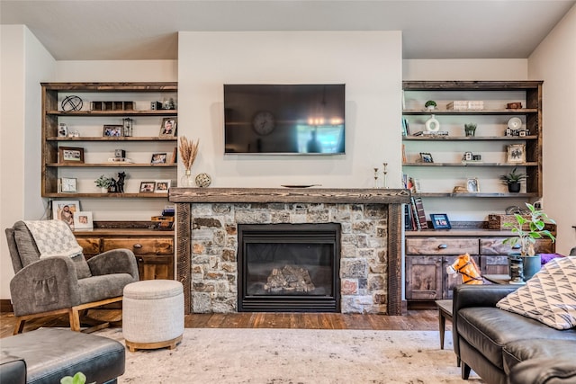 224 Forest Edge Trl, Kalispell, MT 59901 - living room featuring wood finished floors and a stone fireplace