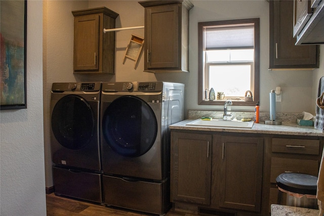 7220 2nd St NW, Havre, MT 59501 - laundry area with washing machine and clothes dryer, cabinet space, dark wood finished floors, and a textured wall