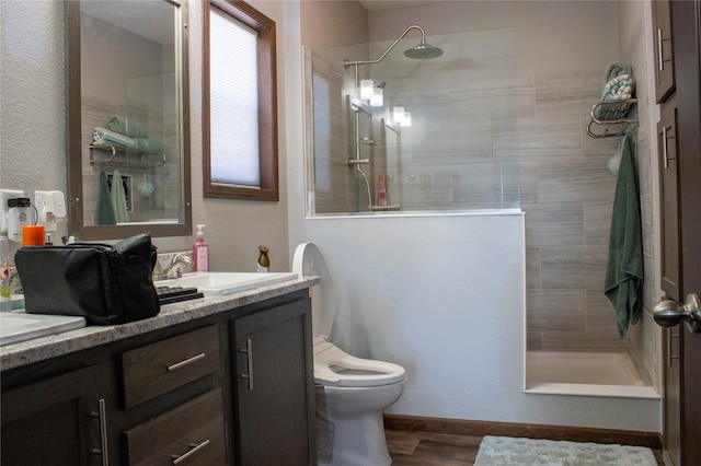 7220 2nd St NW, Havre, MT 59501 - bathroom featuring double vanity, walk in shower, toilet, and wood finished floors