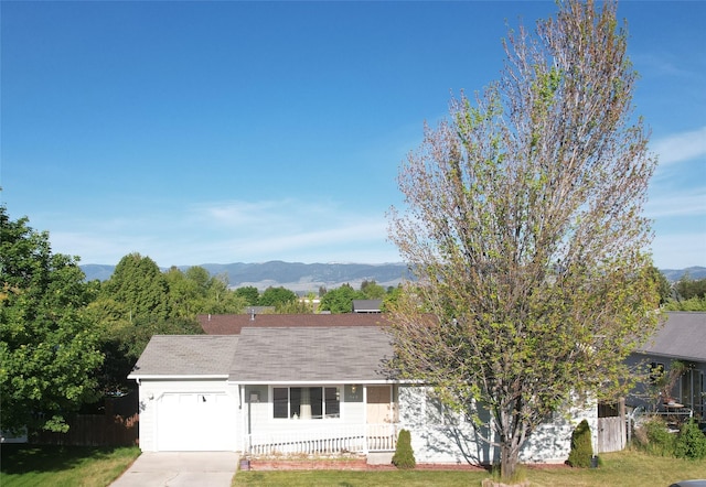 548 N Daly Ave, Hamilton, MT 59840 - view of front facade featuring a garage, concrete driveway, a mountain view, and covered porch