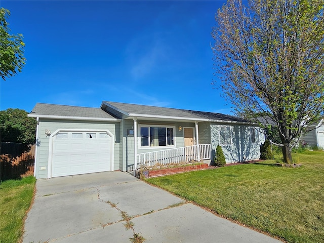 548 N Daly Ave, Hamilton, MT 59840 - single story home featuring a porch, an attached garage, driveway, and a front yard
