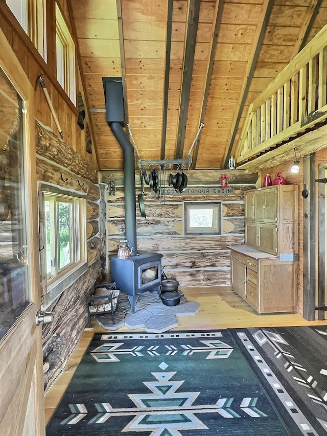 3408 Whiskey Jack Ln, Hamilton, MT 59840 - unfurnished living room with a wood stove, plenty of natural light, a wood ceiling with exposed beams, wood-type flooring, and high vaulted ceiling