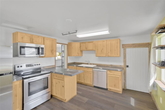 2133 W Sussex Ave, Missoula, MT 59801 - kitchen with appliances with stainless steel finishes, light brown cabinetry, a peninsula, and a sink