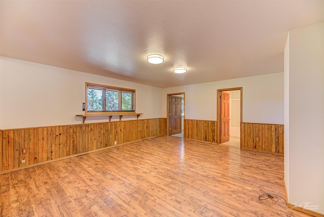 854 State Highway 282, Clancy, MT 59634 - unfurnished room with wainscoting, wood finished floors, and wood walls