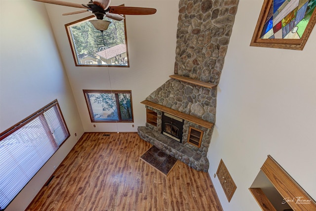 854 State Highway 282, Clancy, MT 59634 - living area featuring a towering ceiling, wood finished floors, ceiling fan, and a fireplace