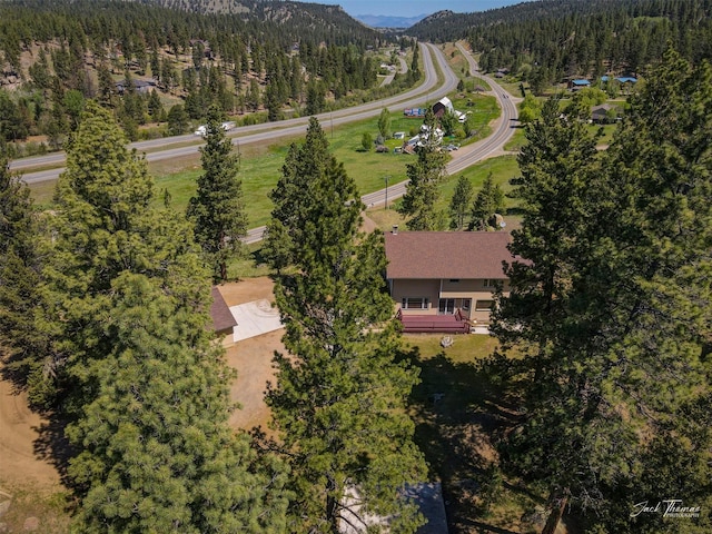 854 State Highway 282, Clancy, MT 59634 - aerial view of property and surrounding area featuring a forest and a mountain backdrop