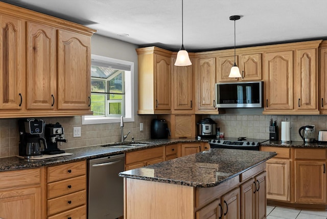 3165 Lamoreux Ln, Missoula, MT 59803 - kitchen with appliances with stainless steel finishes, a sink, decorative backsplash, and a kitchen island