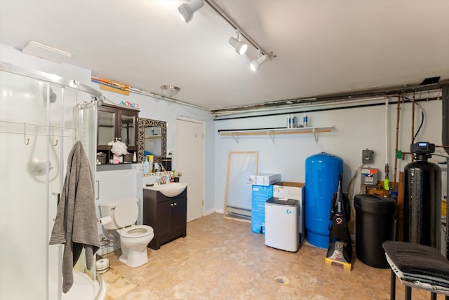 3165 Lamoreux Ln, Missoula, MT 59803 - finished below grade area featuring a water pressure tank, a sink, a water softener, light floors, and a baseboard heating unit
