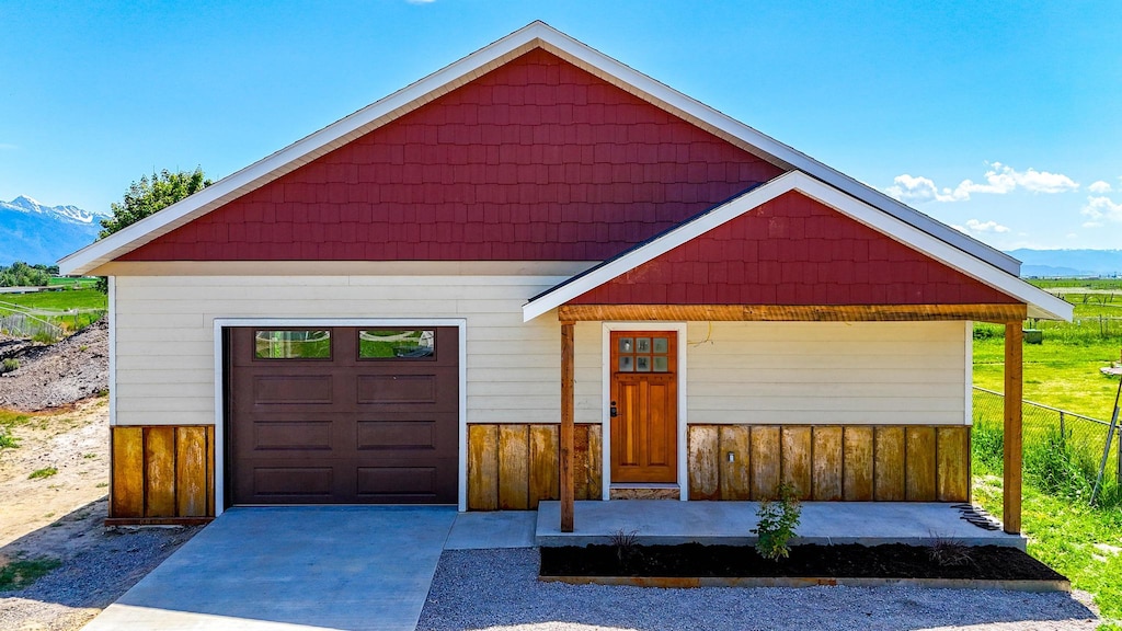 7201/2 6th Ave, Ronan, MT 59864 - view of front of home featuring a mountain view, a garage, and driveway