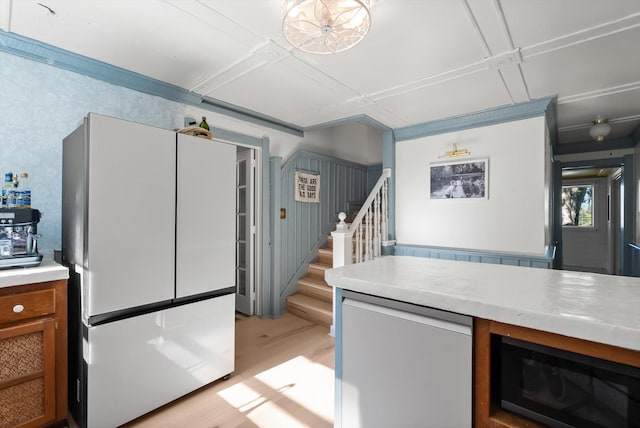 24194 Mt Highway 35, Bigfork, MT 59911 - kitchen featuring freestanding refrigerator, light wood-style floors, light countertops, and brown cabinets