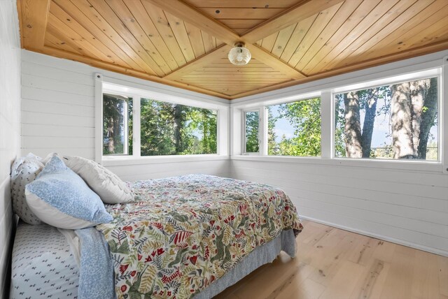 24194 Mt Highway 35, Bigfork, MT 59911 - bedroom with wooden ceiling, wood finished floors, and wooden walls