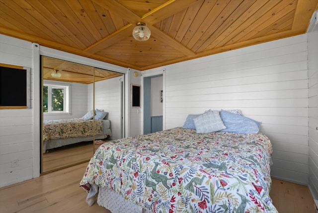 24194 Mt Highway 35, Bigfork, MT 59911 - bedroom featuring wooden ceiling, wood walls, wood finished floors, and a closet