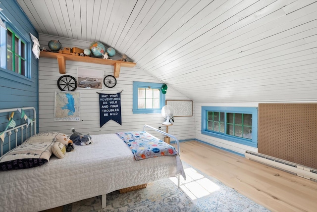 24194 Mt Highway 35, Bigfork, MT 59911 - bedroom featuring lofted ceiling, wood finished floors, baseboard heating, wooden ceiling, and wooden walls