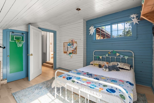 24194 Mt Highway 35, Bigfork, MT 59911 - bedroom with lofted ceiling, light wood finished floors, and wooden walls