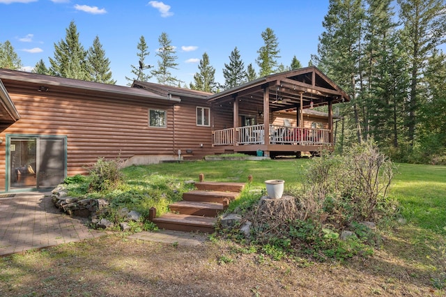 176 Blaine Ridge Rd, Kalispell, MT 59901 - rear view of house with a deck, a lawn, and log veneer siding