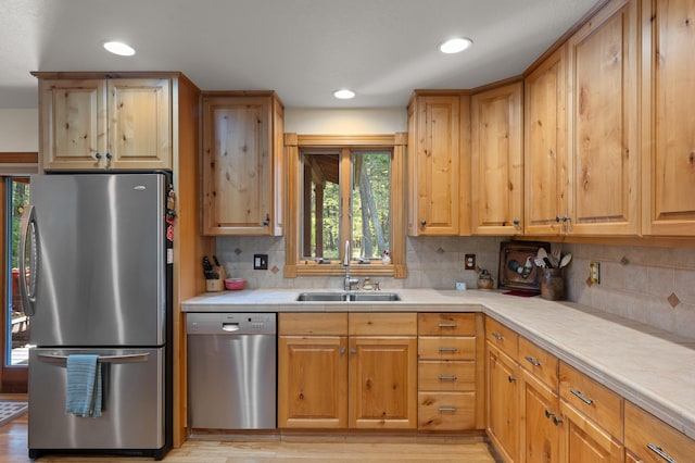 176 Blaine Ridge Rd, Kalispell, MT 59901 - kitchen featuring appliances with stainless steel finishes, tile countertops, backsplash, recessed lighting, and light wood-style floors