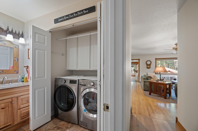 176 Blaine Ridge Rd, Kalispell, MT 59901 - washroom featuring cabinet space, washing machine and dryer, wood finished floors, and ceiling fan
